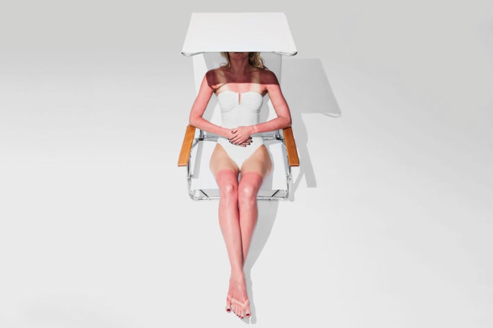 Woman sitting in the Telescope Casual Original Mini-Sun Chaise.